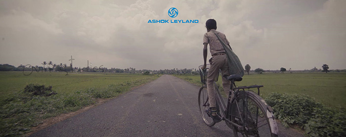 A young student riding a bicycle to school, symbolising education and progress.