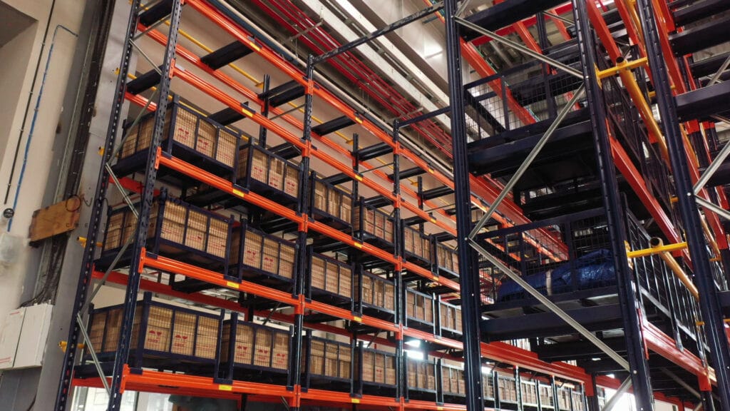 High-capacity warehouse storage racks with industrial crates in corporate video