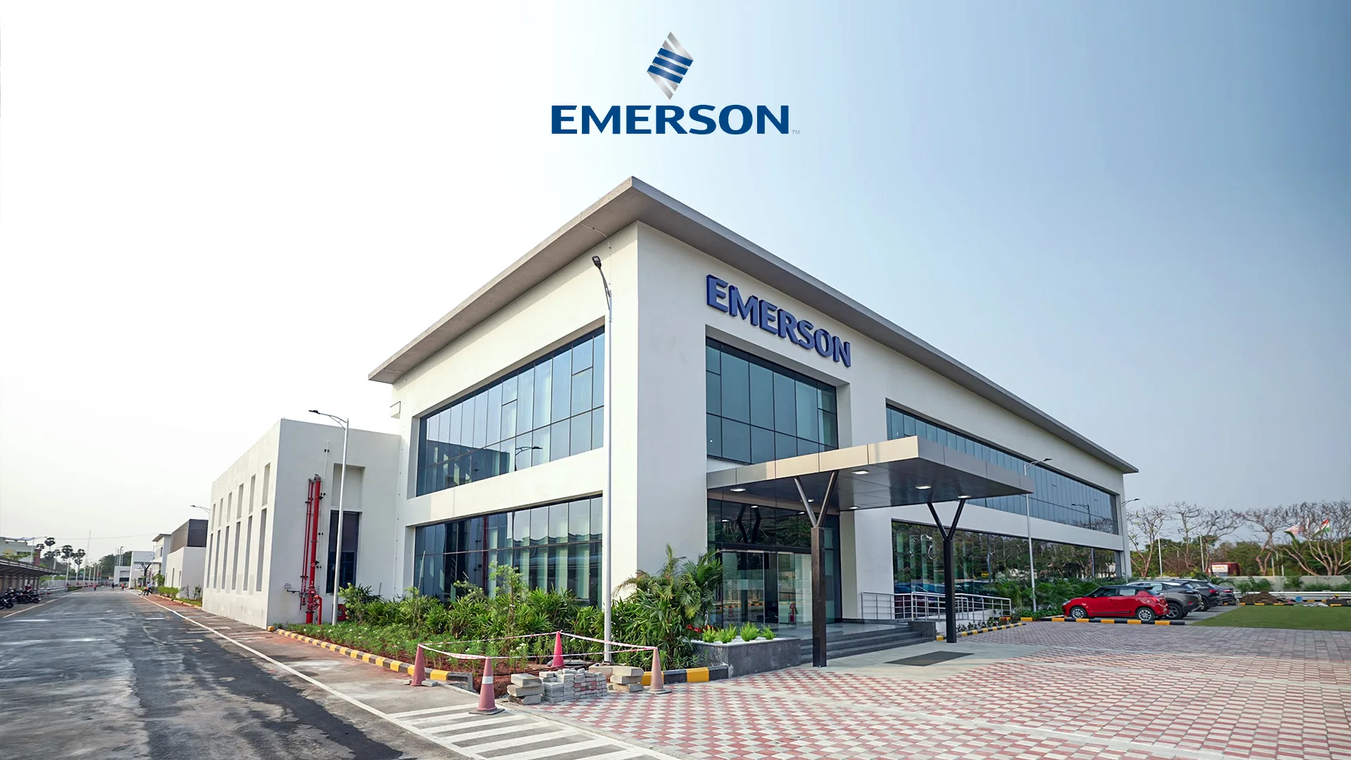 Exterior view of Emerson corporate building in a clean, landscaped setting with parking area.