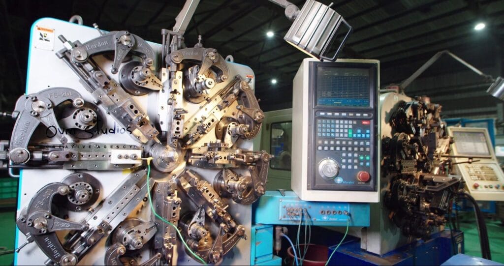 Spring manufacturing machine with coiling mechanism in Corporate Video